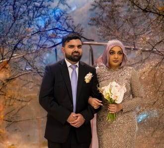 Groom with his bride in a hijab at a South Asian wedding