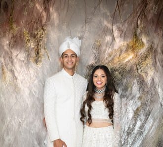 Groom in an ivory sherwani with his bride